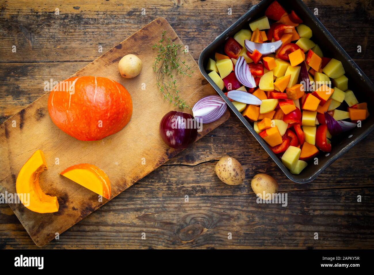 Chopped vegetables: hokkaido pumpkin, potatoes, bell pepper and red onions Stock Photo