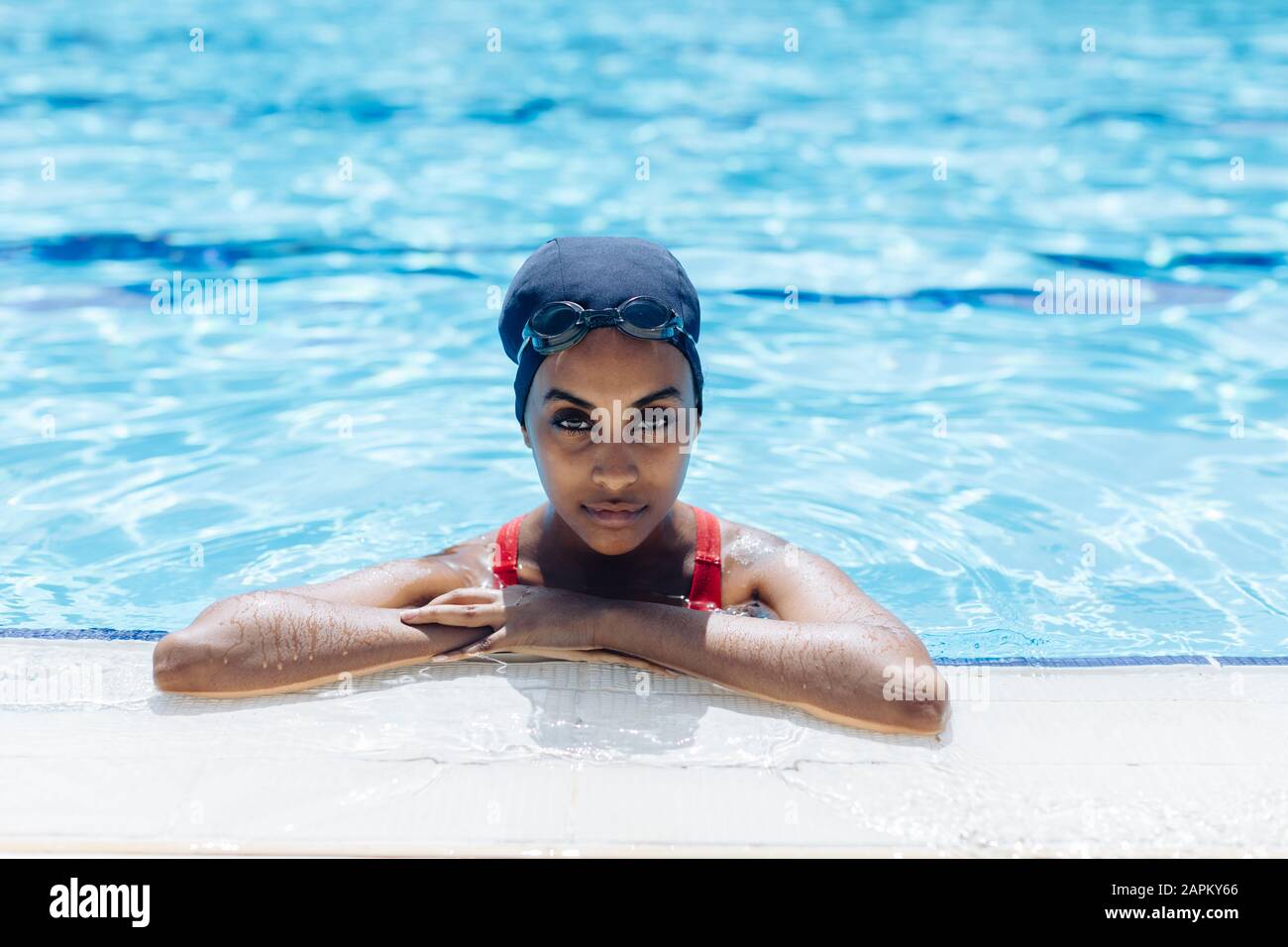 Portrait of young woman in swimming pool Stock Photo - Alamy