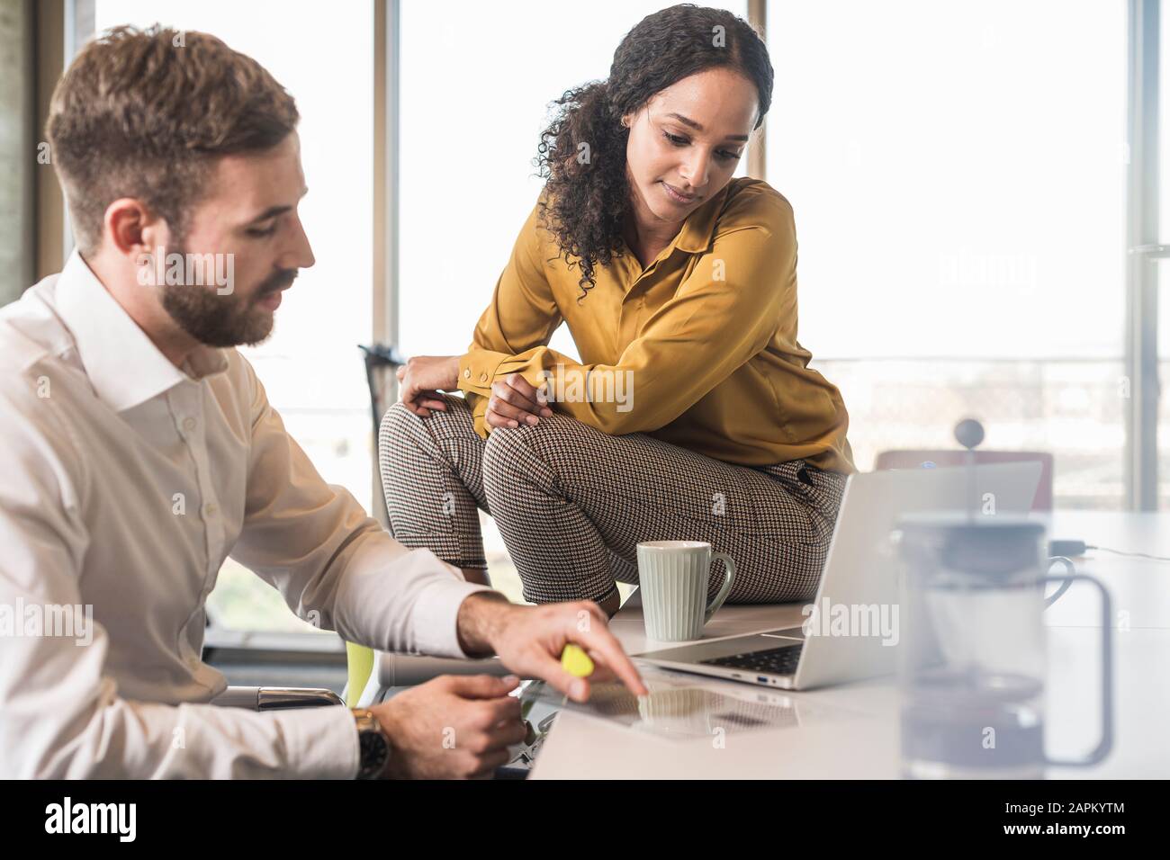 Businessman and businesswoman having a meeting in office Stock Photo ...