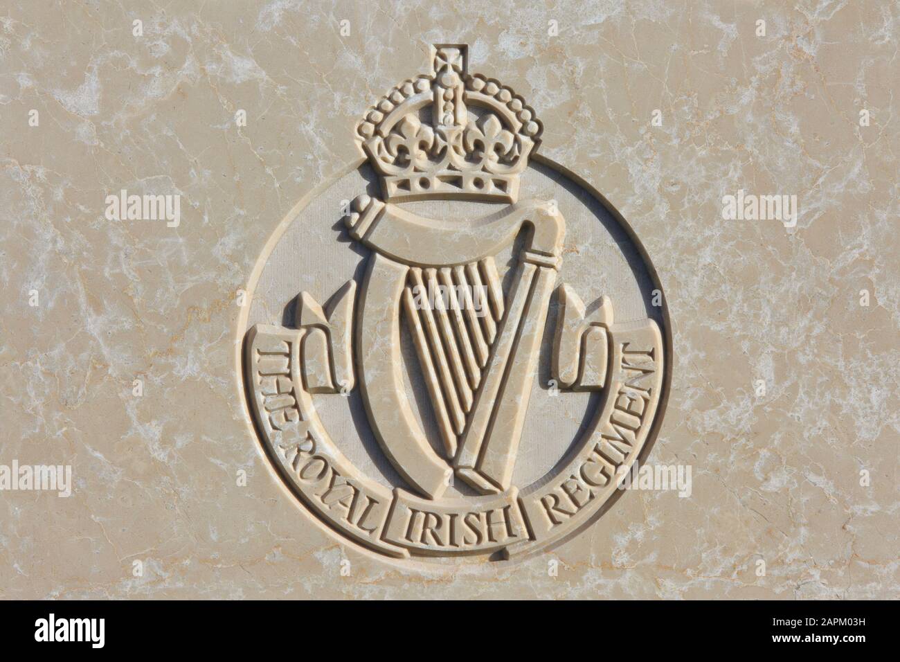 The Royal Irish Regiment (1684-1922) regimental emblem on a World War I headstone at Tyne Cot Cemetery in Zonnebeke, Belgium Stock Photo