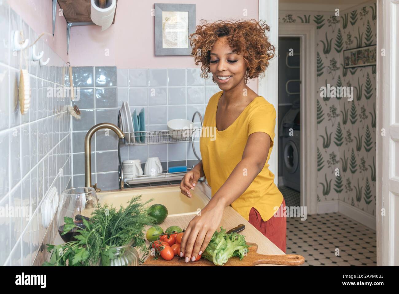 Young woman in kitchen preparing healthy meal Stock Photo