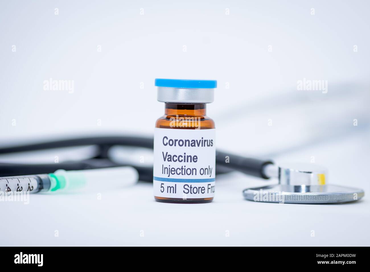 Coronavirus vaccine vial with stethoscope and syringe Stock Photo