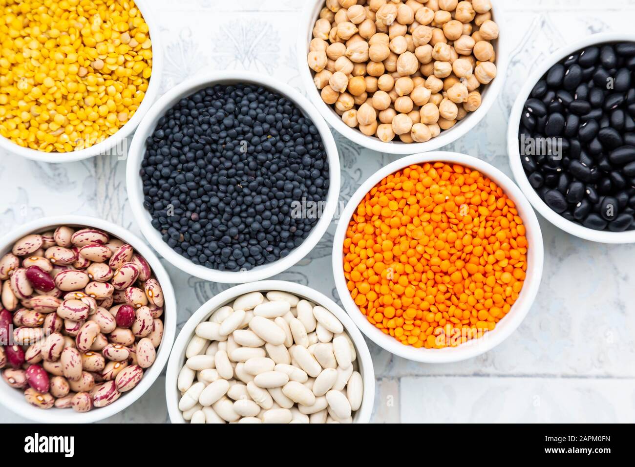 Various legumes in bowls chickpeas, cannellini beans, quail beans