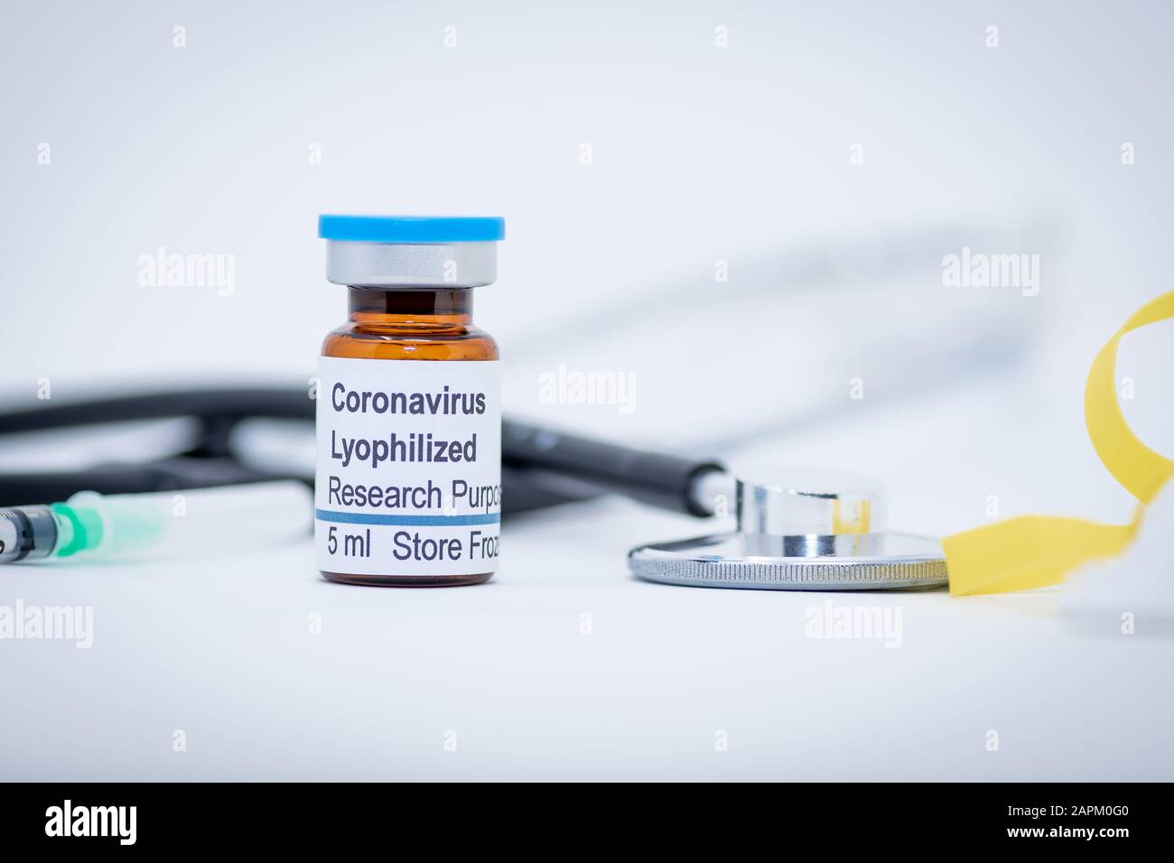 Coronavirus vaccine vial with stethoscope and syringe Stock Photo