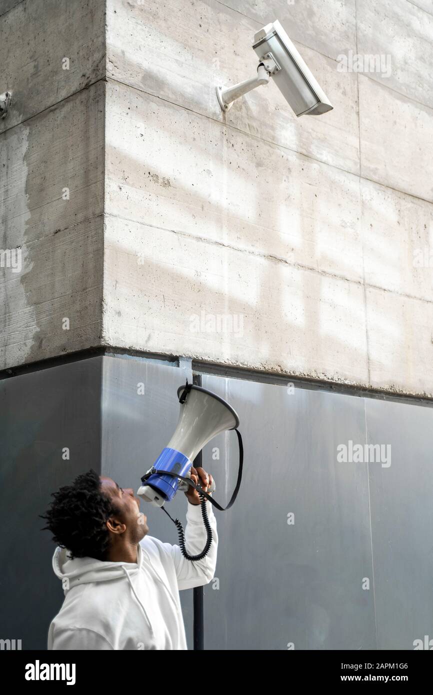 Mature man holding megaphone and screaming Stock Photo