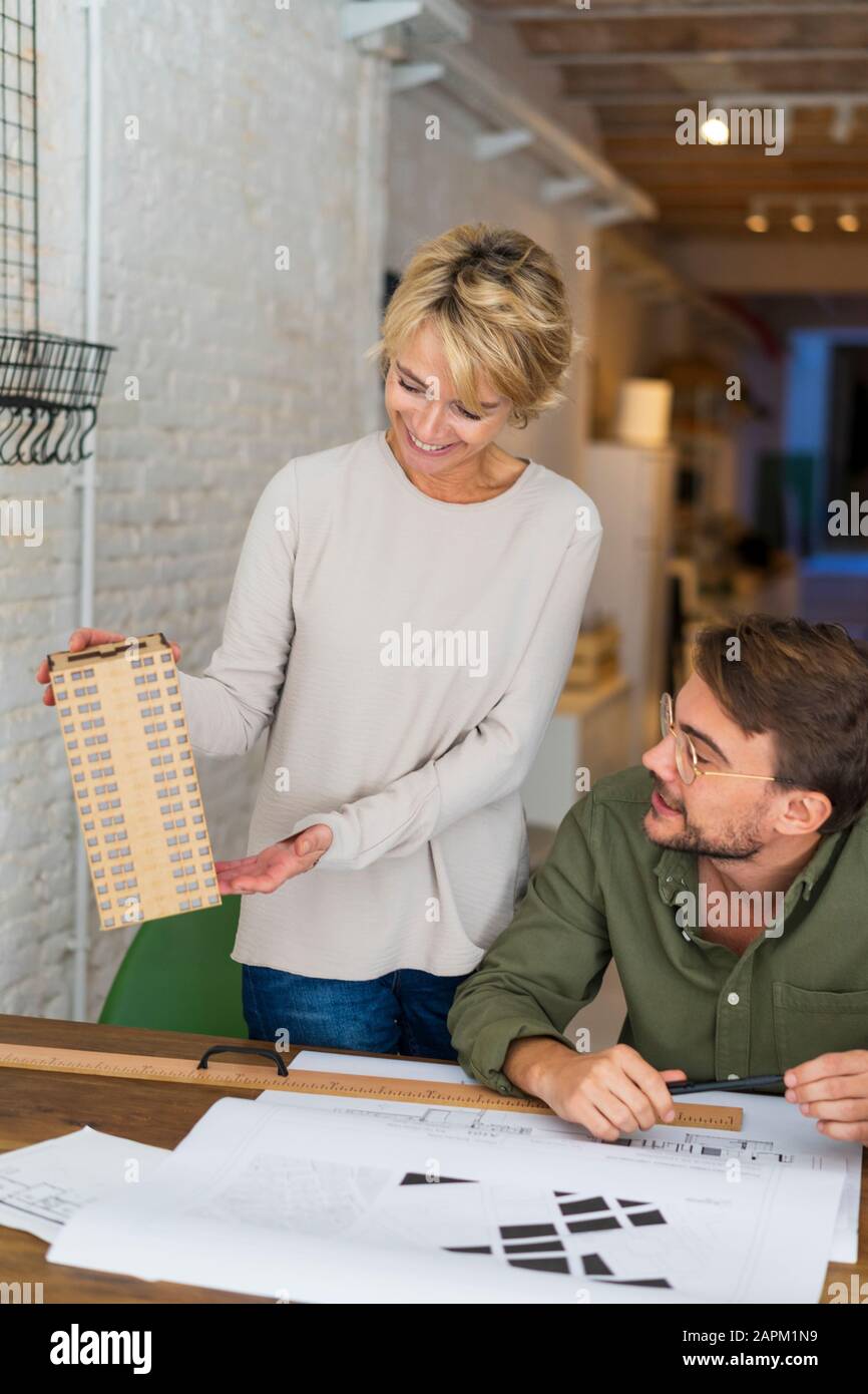 Two architects looking at architectural model in an office Stock Photo