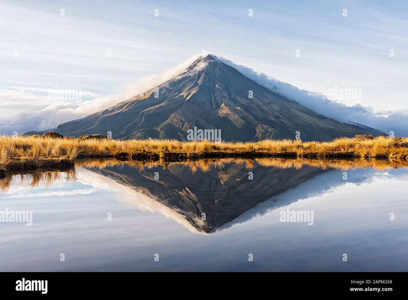 New Zealand, Mount Taranaki volcano reflecting in shiny lake at dawn Stock Photo
