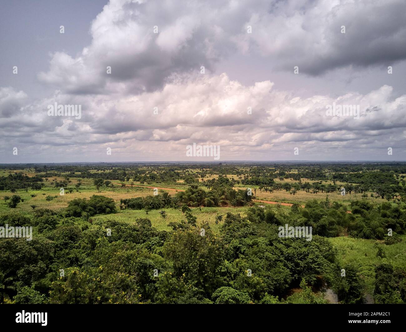 Benin, Large white clouds over green African landscape Stock Photo