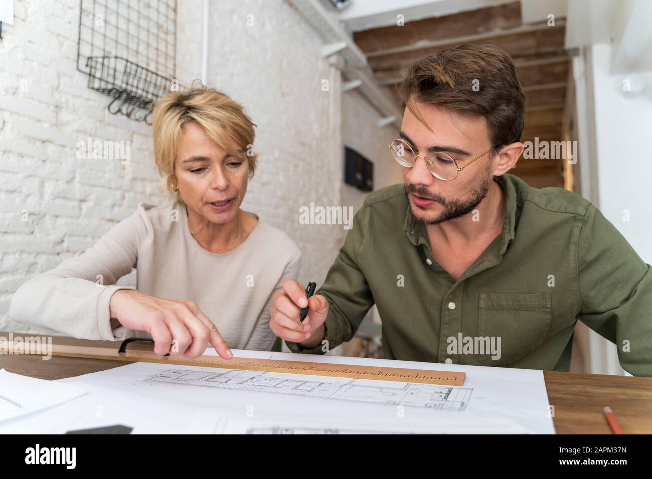 Two architects working together at desk in office Stock Photo