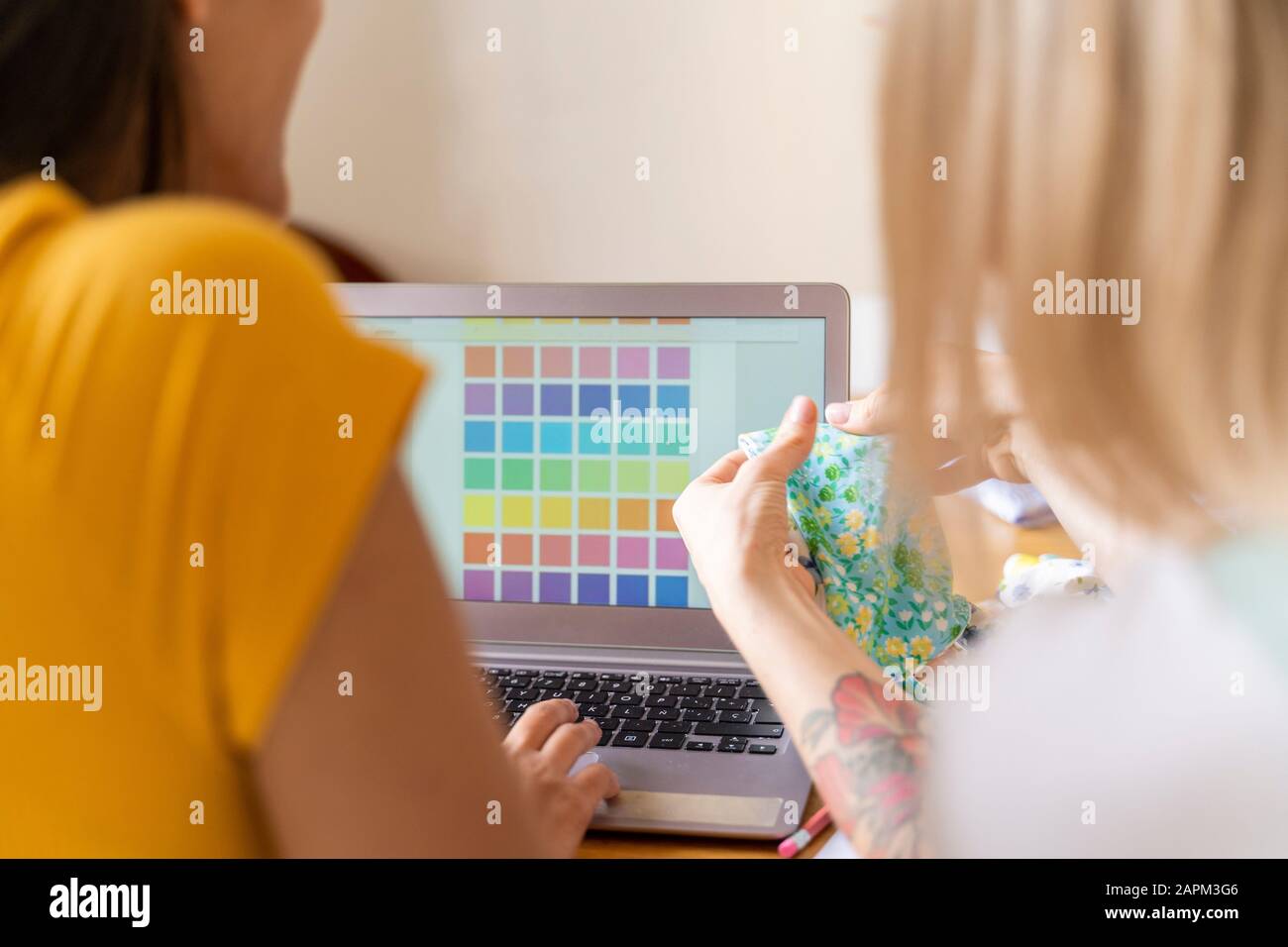 Fashion designers working with laptop and color samples Stock Photo