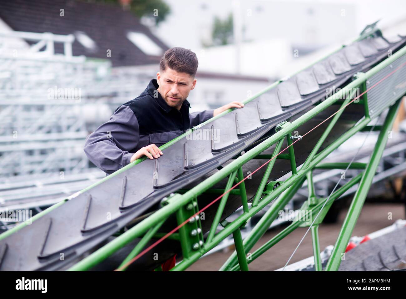 Skilled worker, working in conveyor belt shop Stock Photo