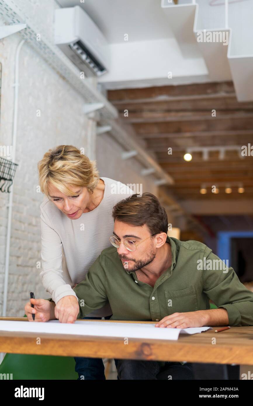 Two architects working together at desk in office Stock Photo