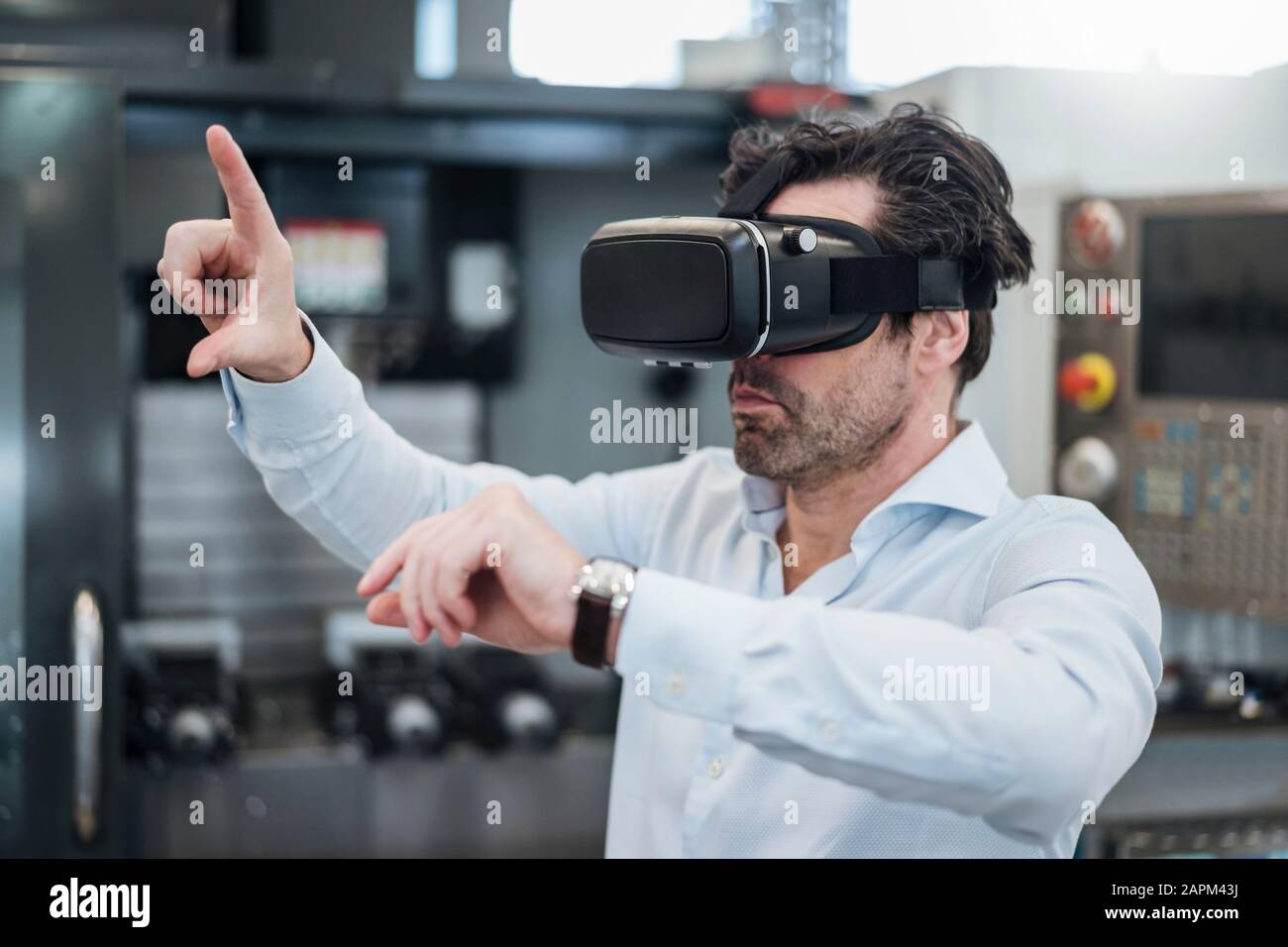 Businessman using VR glasses in a factory Stock Photo - Alamy