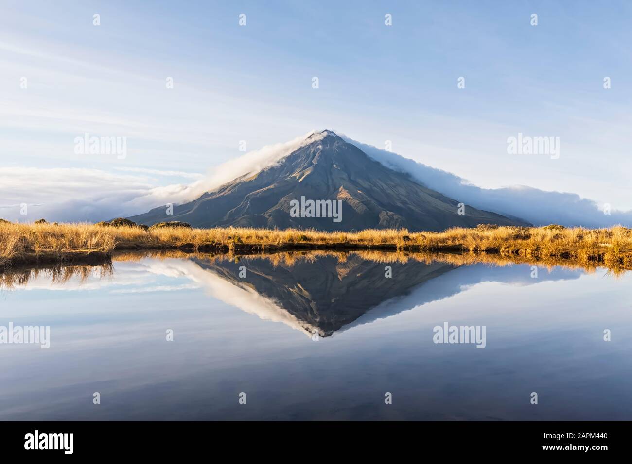 New Zealand, Mount Taranaki volcano reflecting in shiny lake at dawn Stock Photo