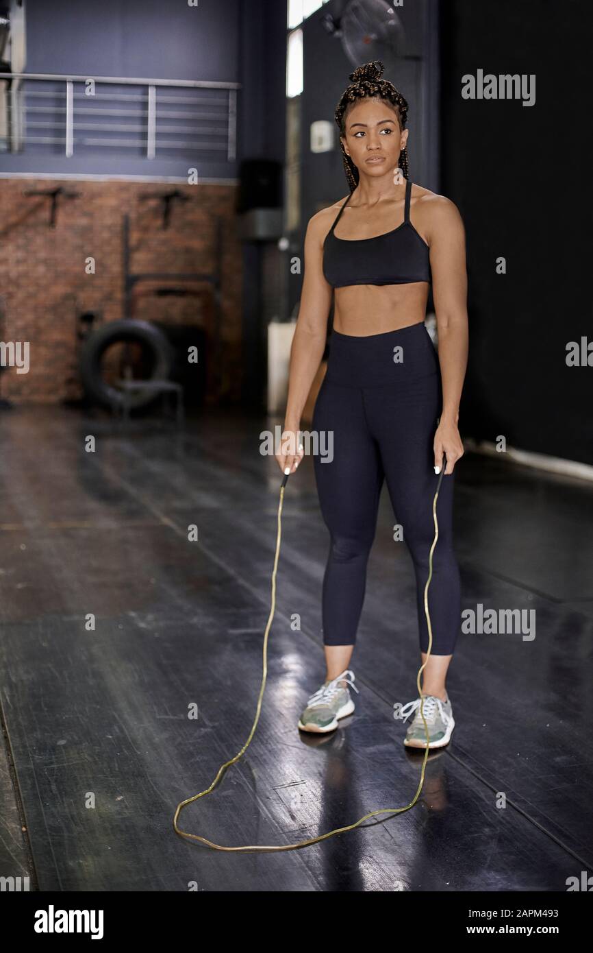 Female athlete skipping rope in gym Stock Photo Alamy