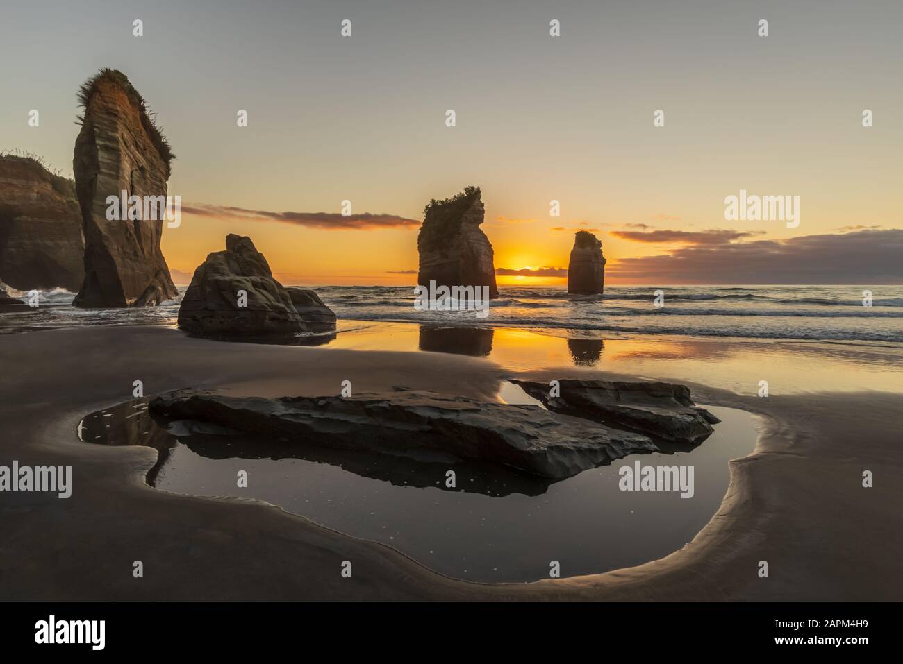 New Zealand, New Plymouth District, Tongaporutu, Three Sisters rock formation at sunset Stock Photo