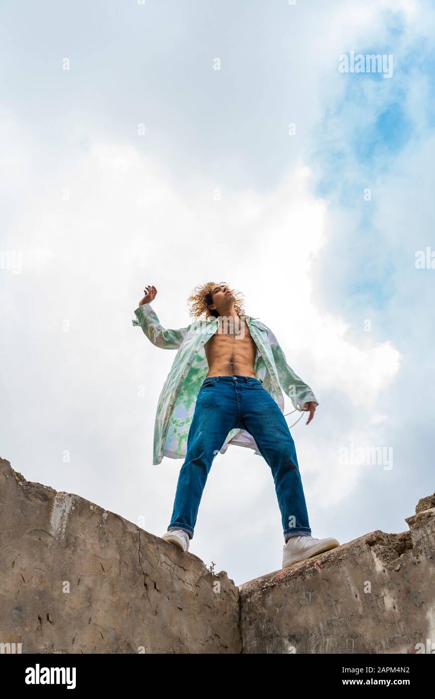 Young blond man dancing on a wall Stock Photo