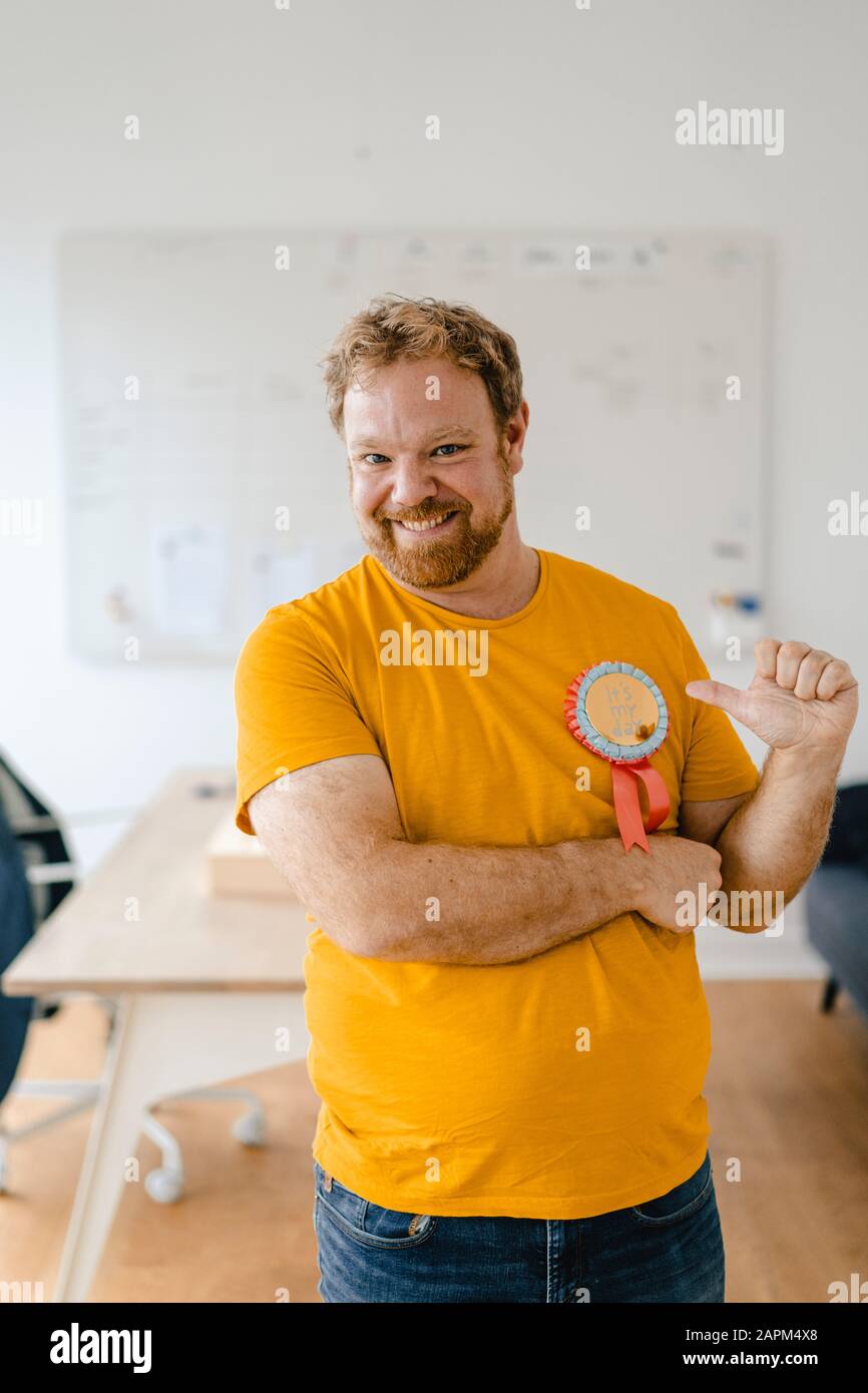 Portrait of a happy casual businessman with an award in office Stock Photo