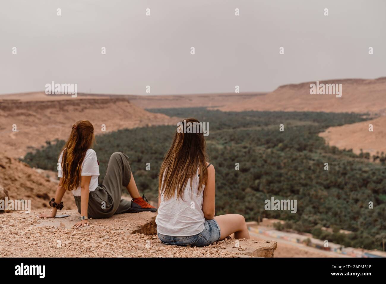 Back view two friends sit hi-res stock photography and images - Alamy