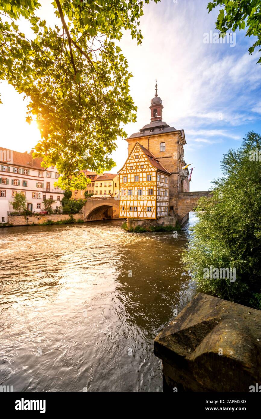 Germany, Bavaria, Bamberg, Regnitz river in front of historical town hall at sunset Stock Photo