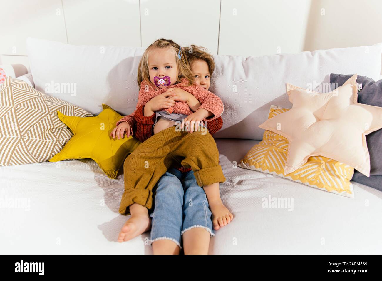 Two Sisters Lying On Sofa High Resolution Stock Photography and Images ...
