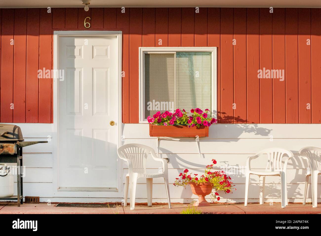 Typical small clean motel room with deck furniture, Atlantic coast island, Canada Stock Photo