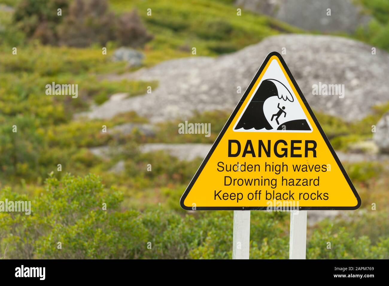 Sign warning about danger of sudden high waves on the Nova Scotia coastline, Canada Stock Photo