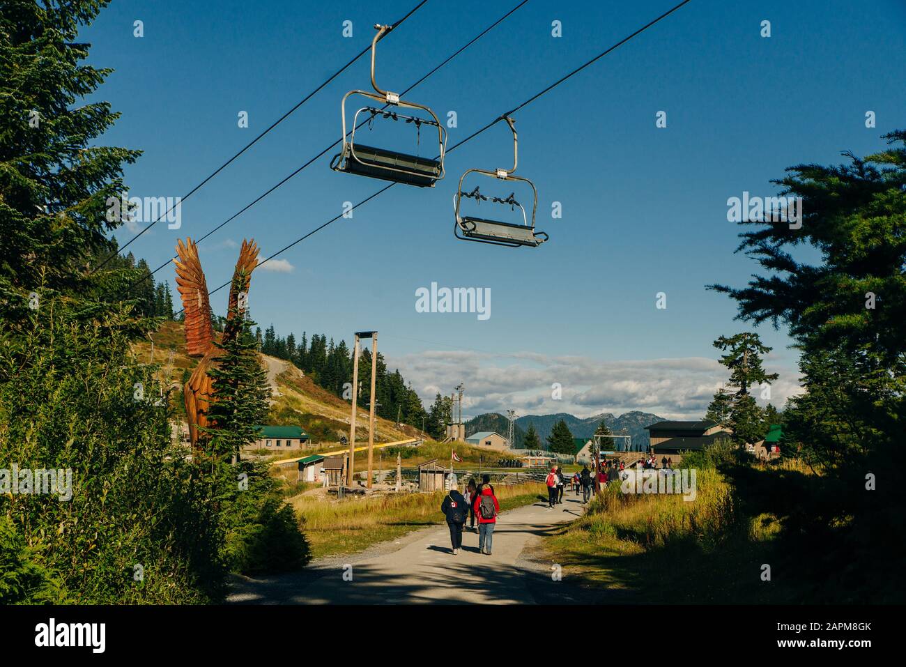 Vancouver, British Columbia, Canada - SEptember, 2019 Grouse Mountain chair lift and windmill in summertime Stock Photo