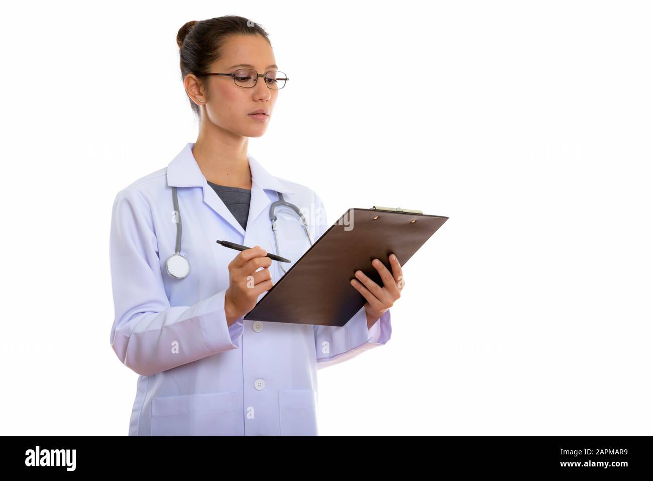 Studio shot of young beautiful multi ethnic woman doctor isolated ...