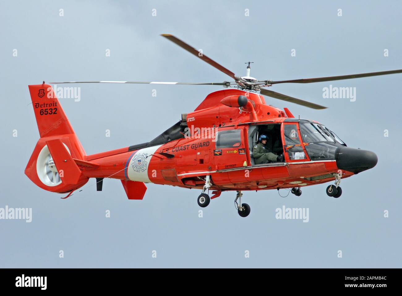 A U.S. Coast Guard HH-65 Dolphin Helicopter during a demonstration flight at the Wings and Wheels International Airshow. Stock Photo