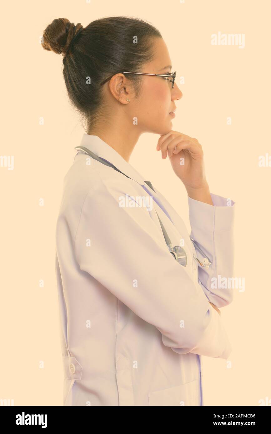 Studio shot of young beautiful multi ethnic woman doctor isolated ...