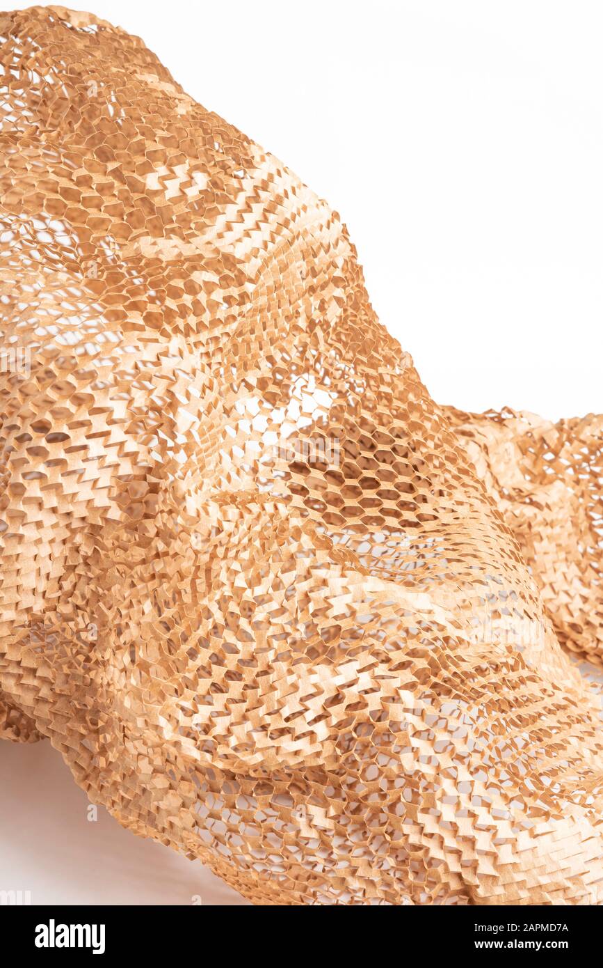 A closeup shot of a spread out brown kraft packaging paper filler set on white background Stock