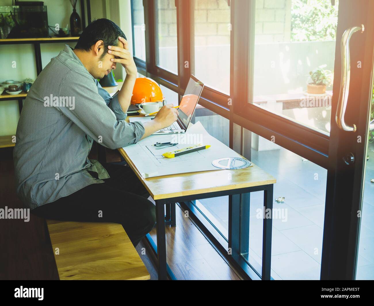Architect in stress, tired, sad, disappointed with project problem. Stock Photo