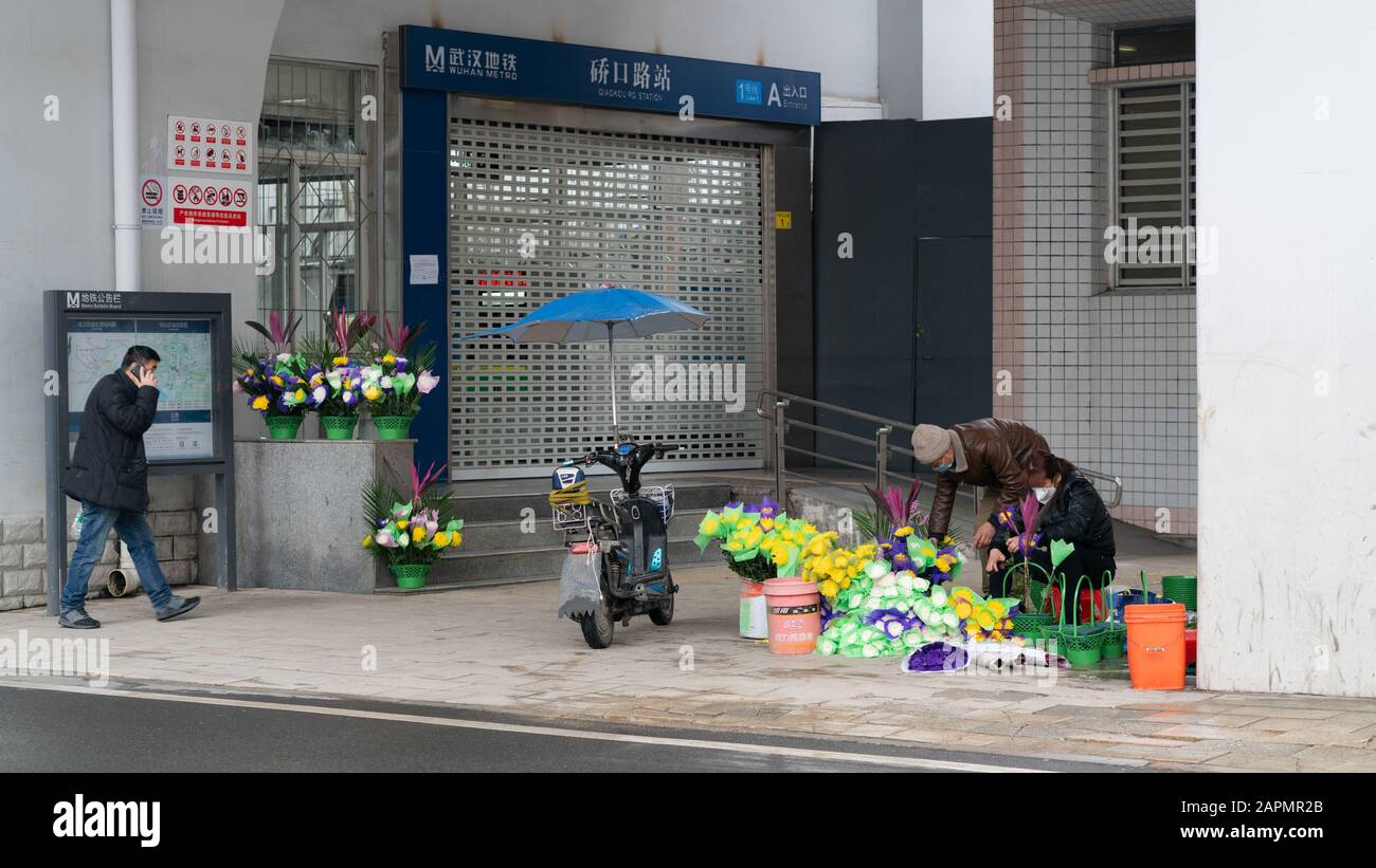 Wuhan China , 24 January 2020 : Closed subway station and people wearing masks during second day of the lockdown of the city to prevent coronavirus ep Stock Photo