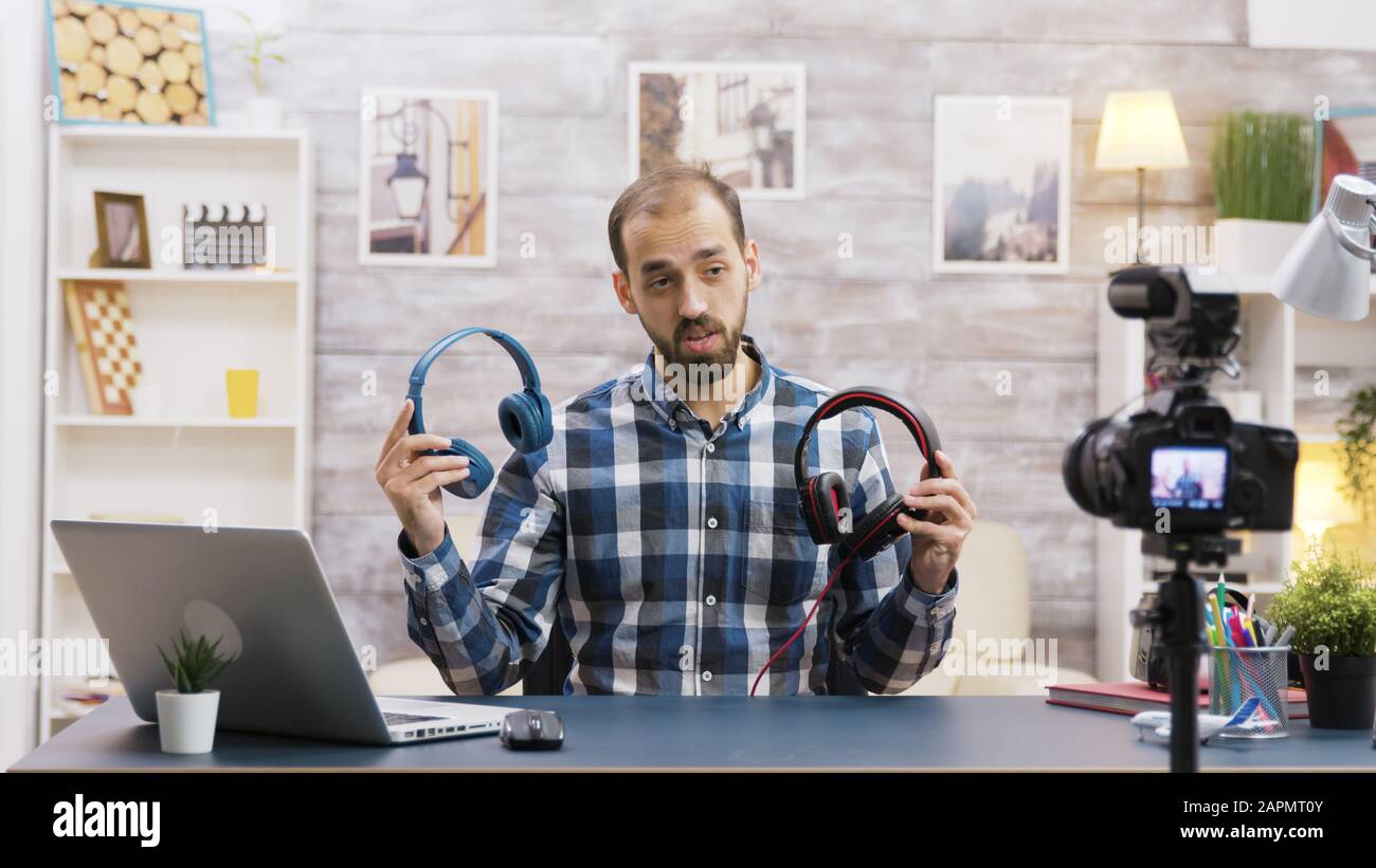 Famous vlogger recording a review and testing headphones. Creative content creator. Stock Photo
