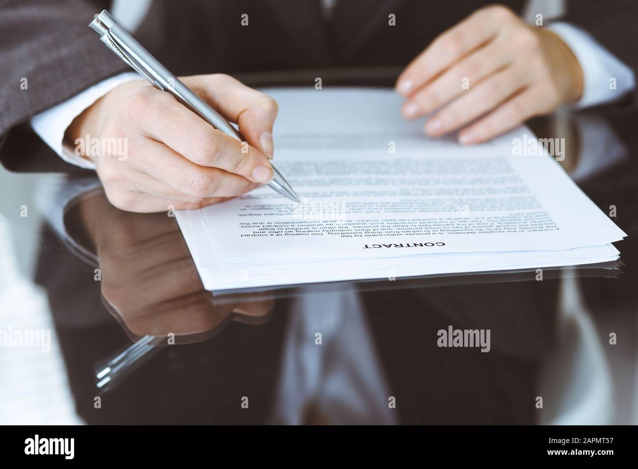 Unknown female hands with pen over document of contract. Agreement ...