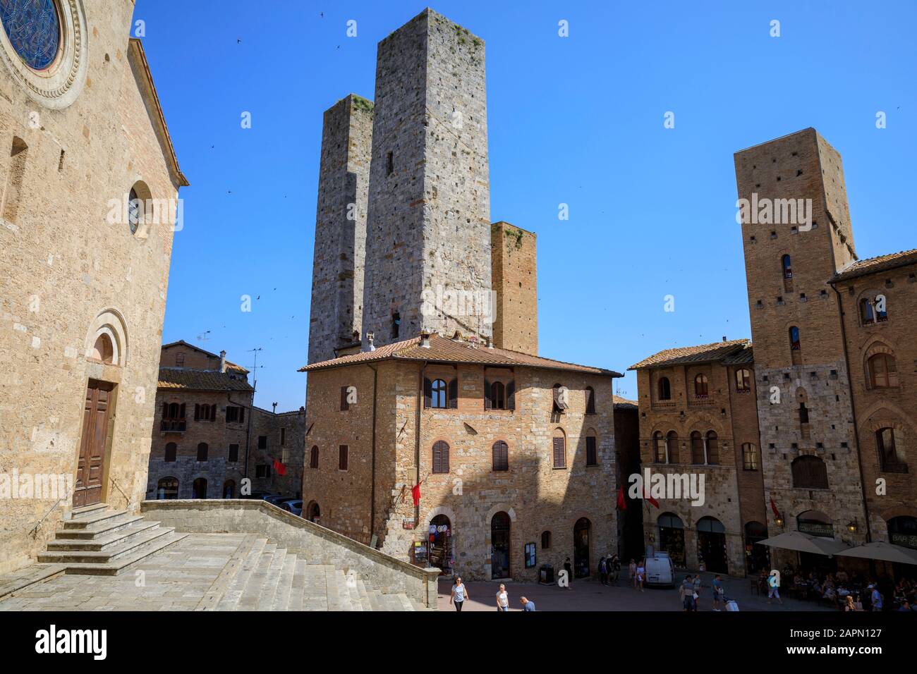 Duomo di San Gimignano (L) & Salvucci Towers (C) in San Gimignano, Italy. Stock Photo