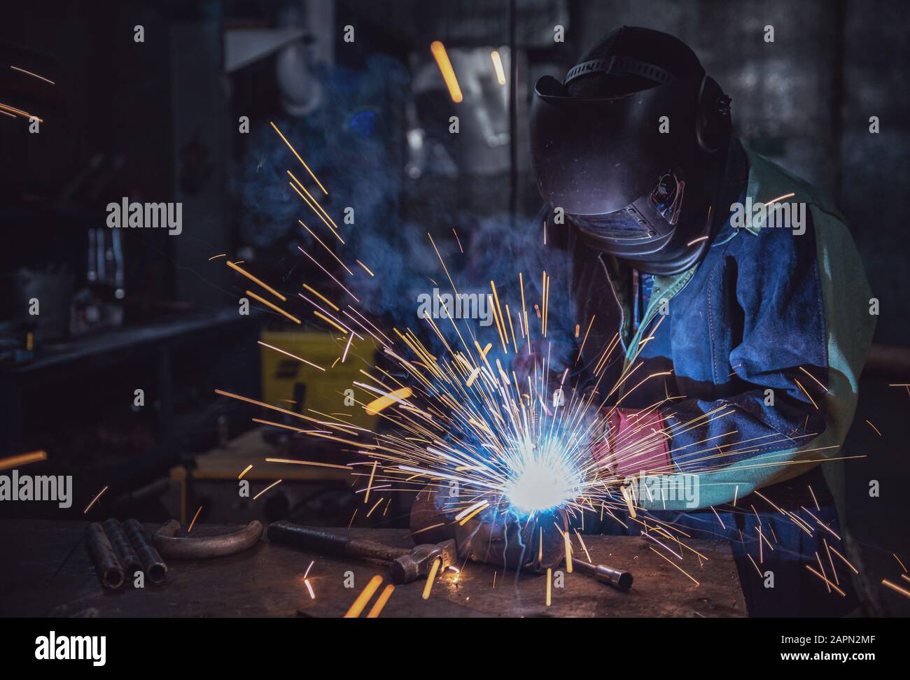 Industrial Worker labourer at the factory welding steel structure Stock Photo