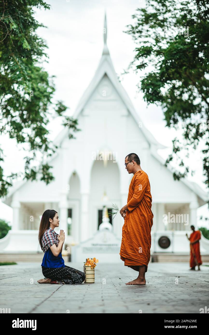 Gå igennem Beloved kugle Thai woman with traditional dress sit pray respect monk, present buddhism  people Make merit with monk that representative of Buddha. Woman Make merit  Stock Photo - Alamy