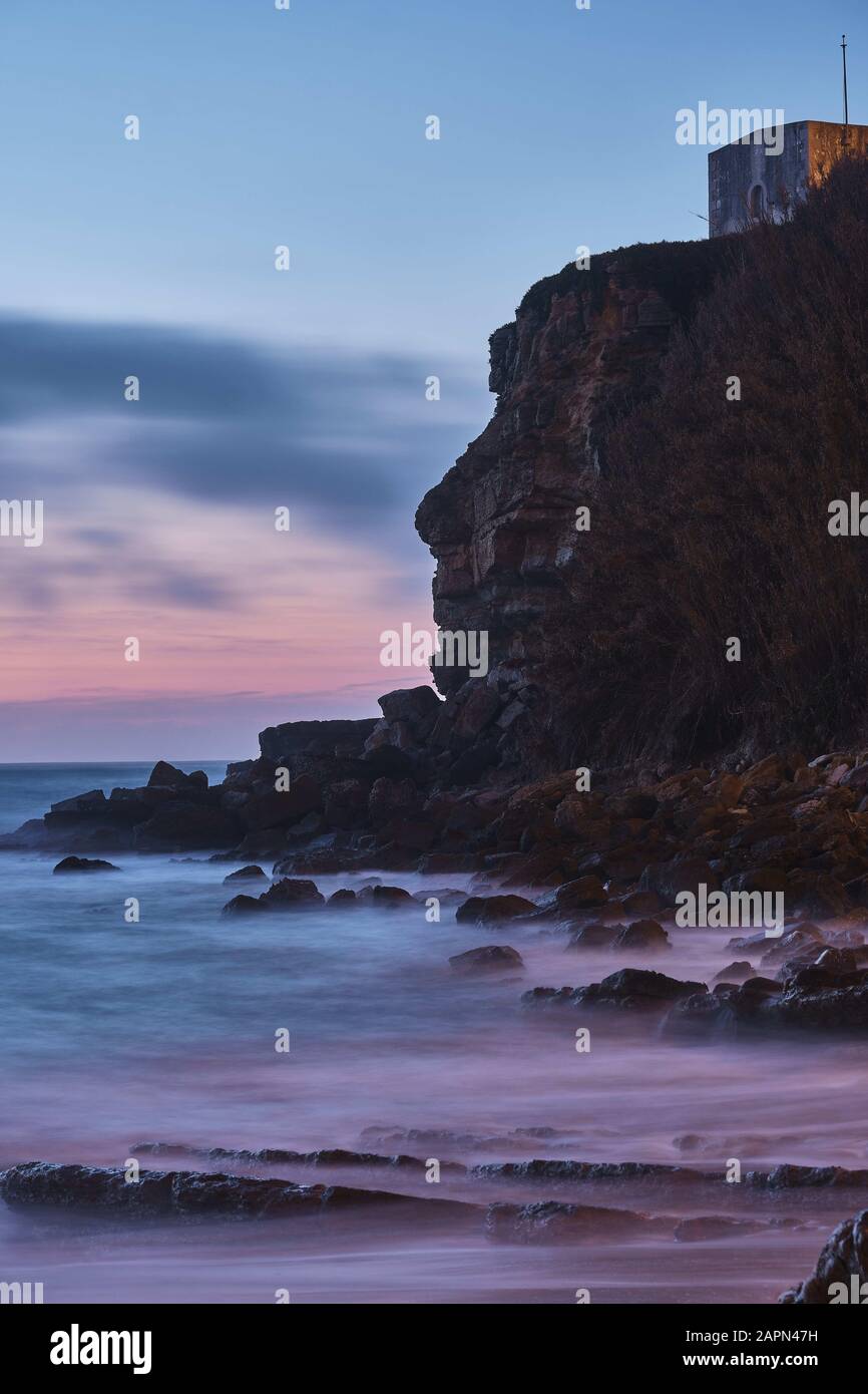 Vertical shot of a building at the top of the cliff Stock Photo - Alamy