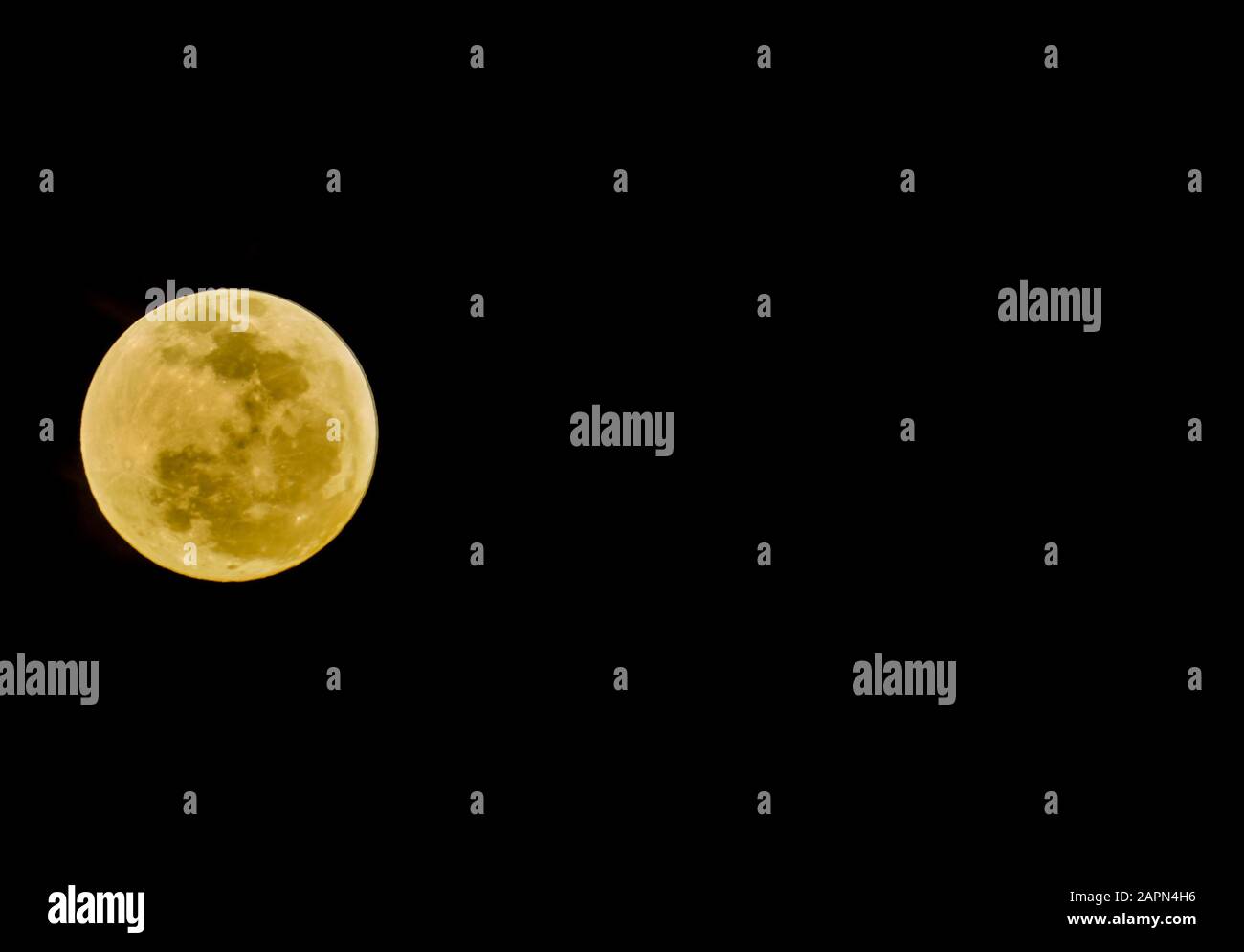 Landscape Shot Of A Yellow Full Moon With Black Color In The Background Stock Photo Alamy