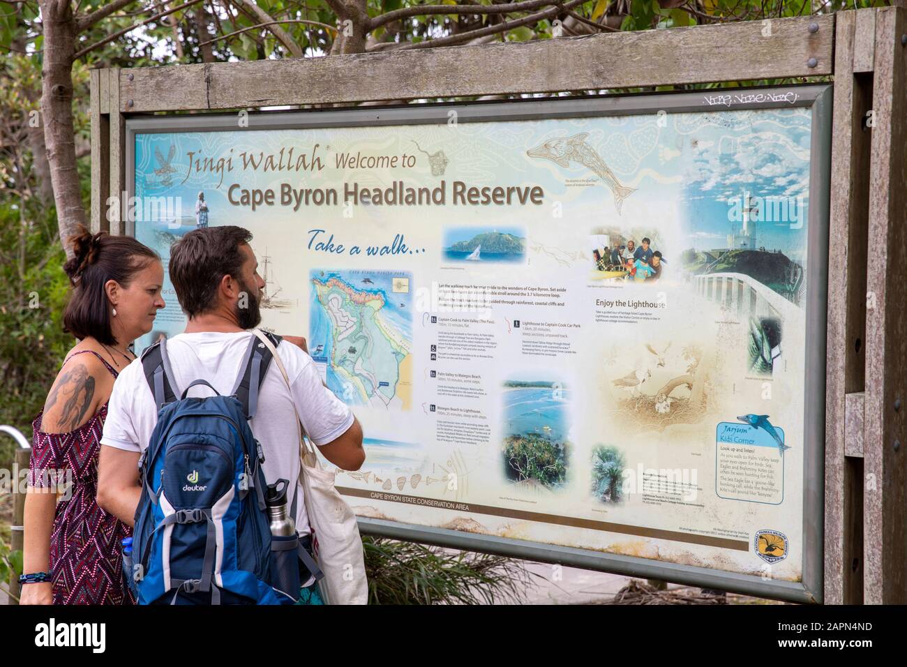 Cape Byron Headland Reserve, male and female tourists view the information map on their hike in Byron Bay,New South Wales,Australia Stock Photo