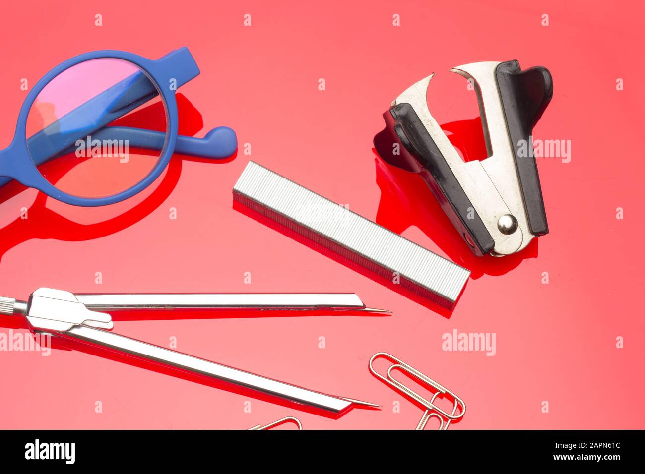 Diverse office supplies, clips, pencils, pen, staples, stapler, money,  coins, compass; professional office or high school or university student  office Stock Photo - Alamy