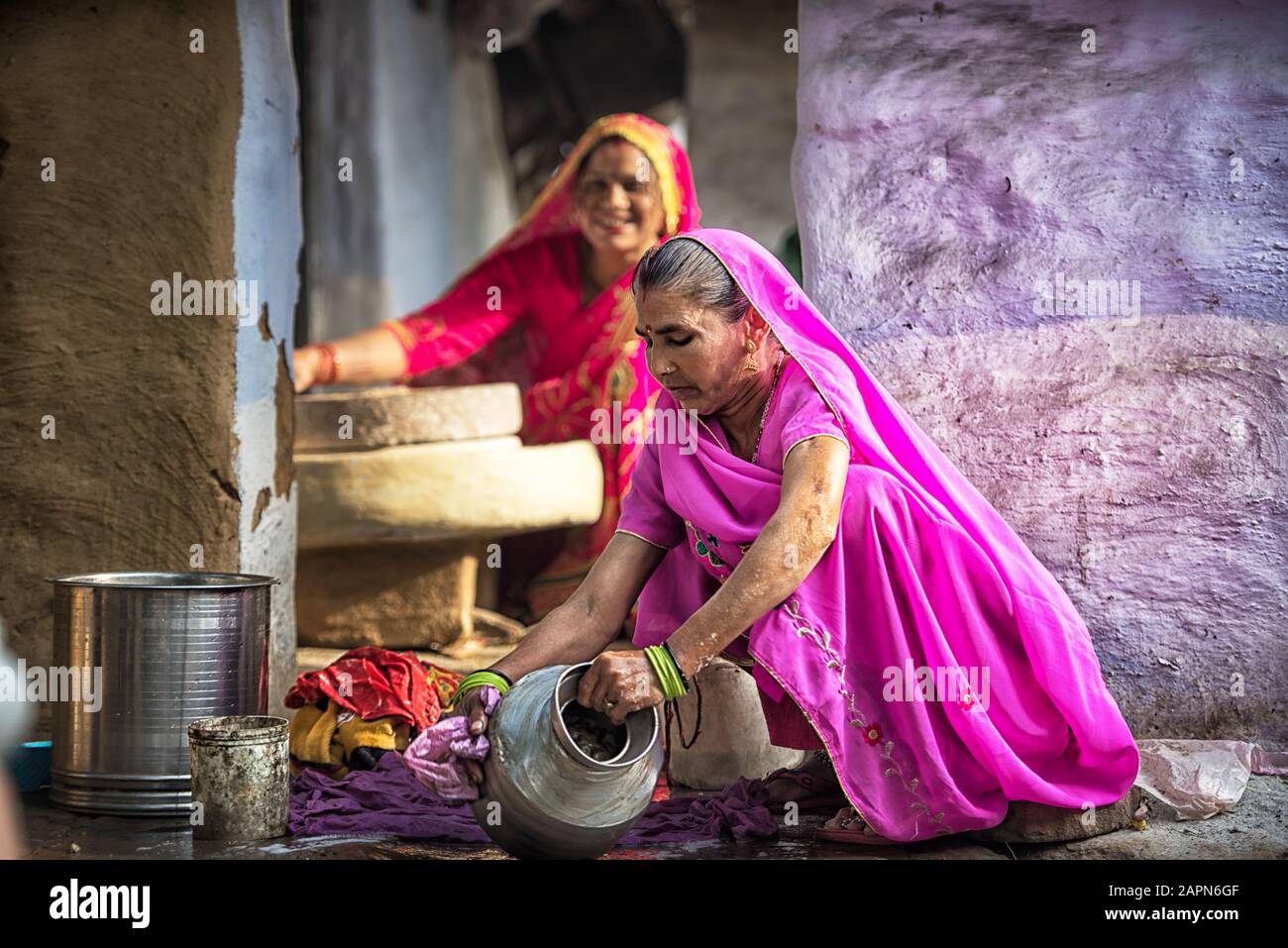 MATHURA, INDIA - Feburary 23,2018: Woman cleaning utensils at home, Mathuda, India. Stock Photo
