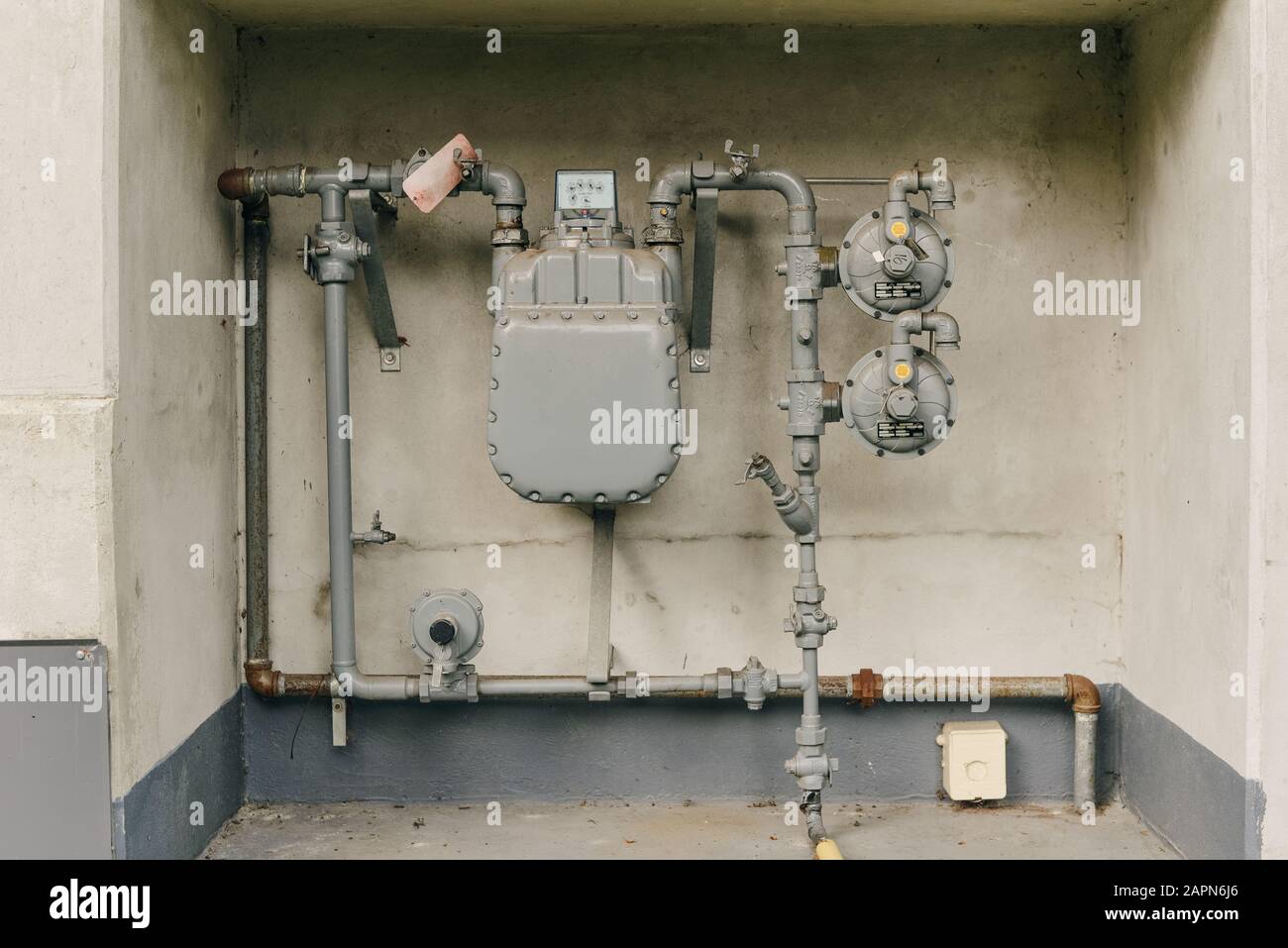 Heating system. Instalaltion of water pipes on the grey concrete wall. Plumbing connection