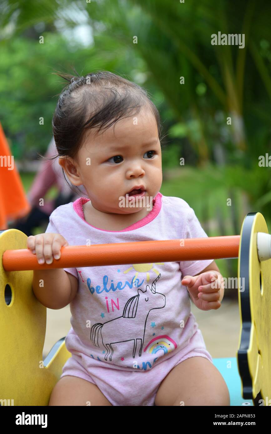 1 years, asia face, baby girl, playing in the park, public space Stock Photo