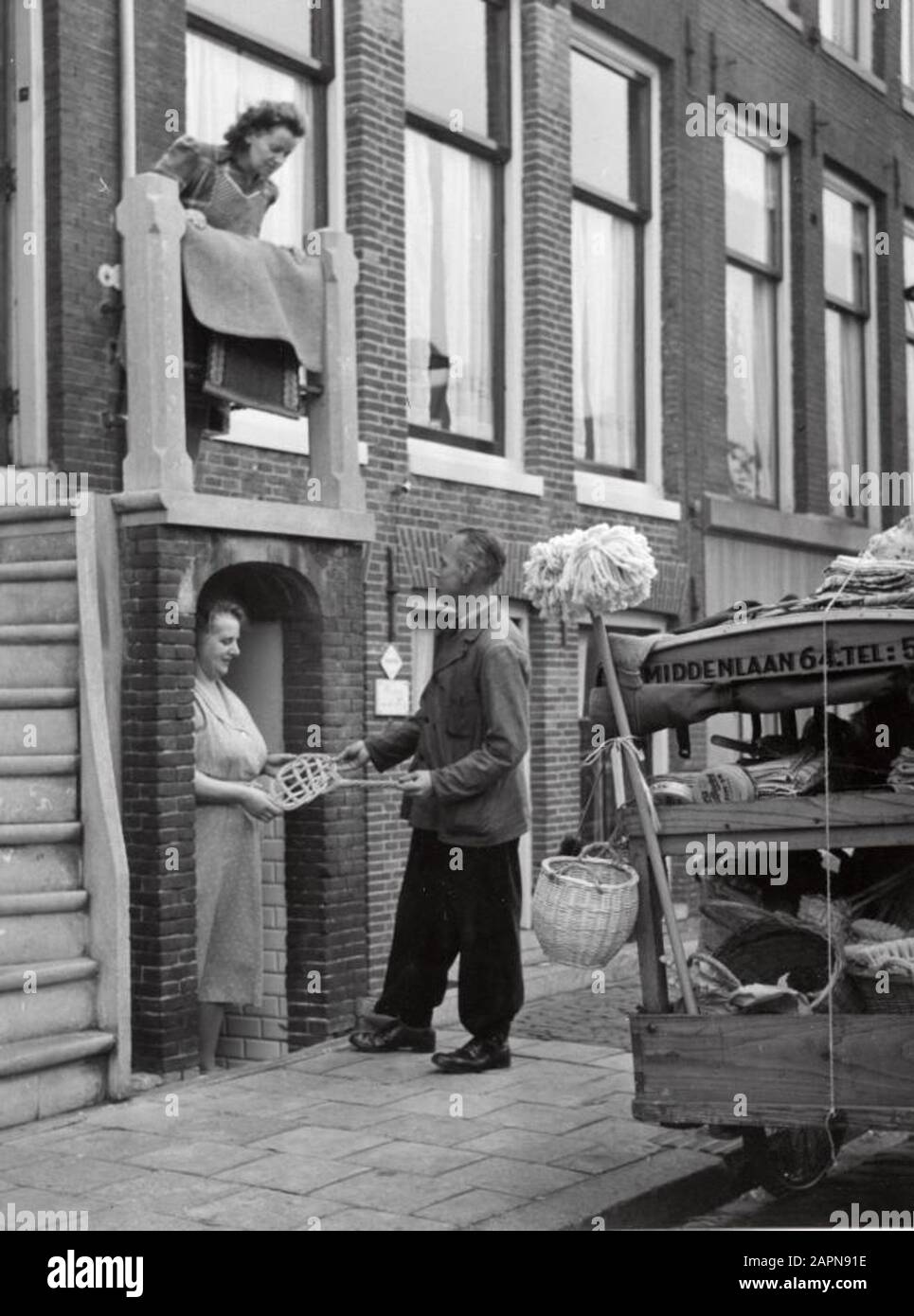 Household Goods Trader Goes Along The Doors With His Merchandise