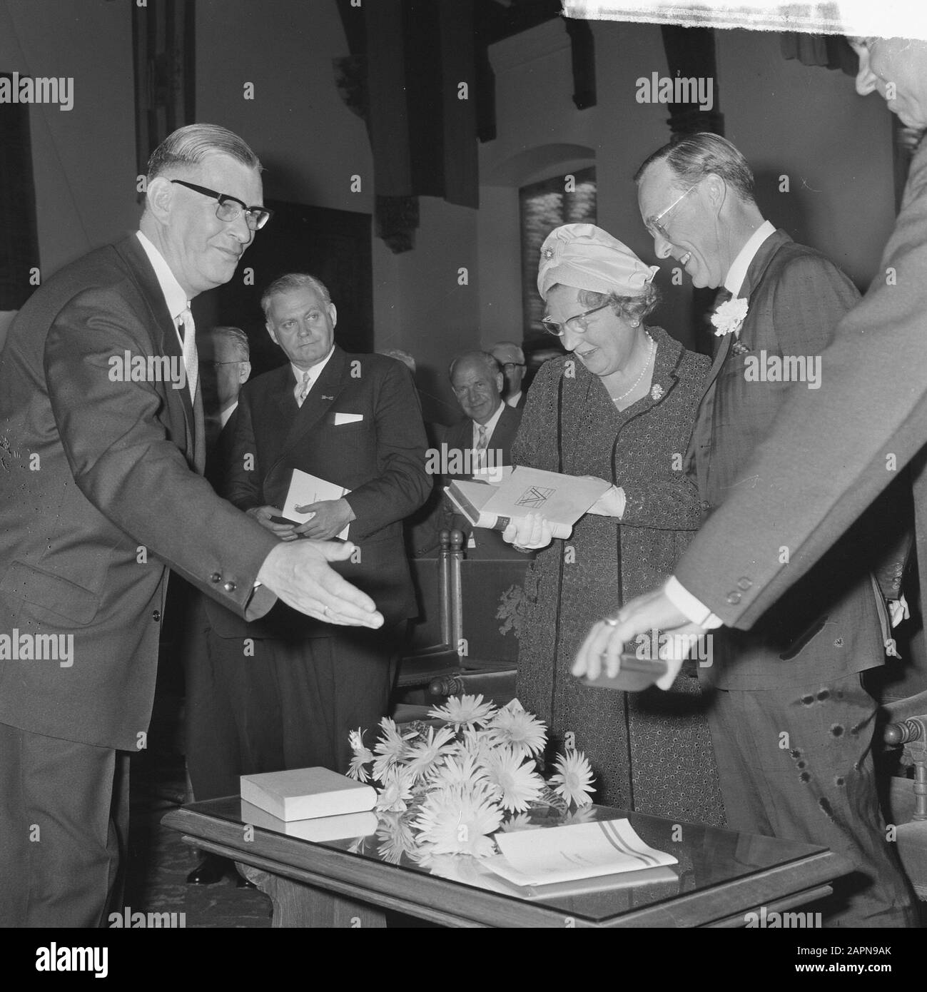 Freedom slustrum ex-political prisoners in The Hague  Queen Juliana receives a book and prince Bernhard a special badge Date: 23 June 1965 Location: The Hague, Zuid-Holland Keywords: books, queens, tokens, princes Personal name: Bernhard (prince Netherlands), Juliana (queen Netherlands) Stock Photo