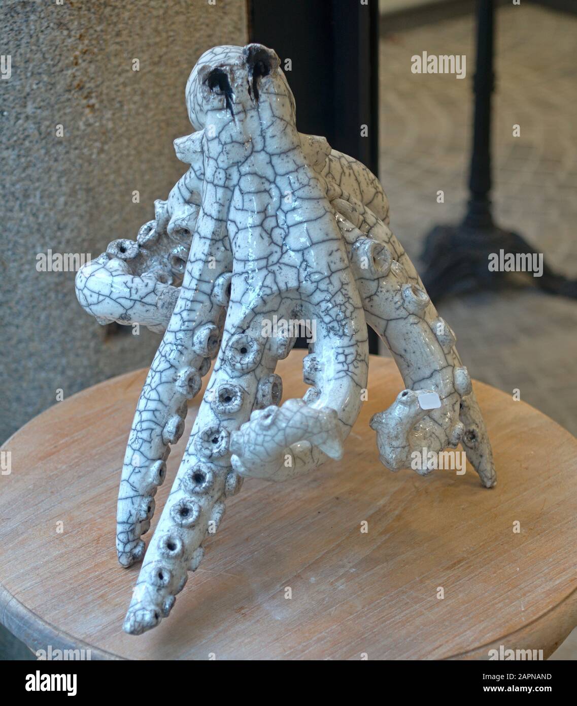 Ceramic figure of octopus on wooden table Stock Photo - Alamy