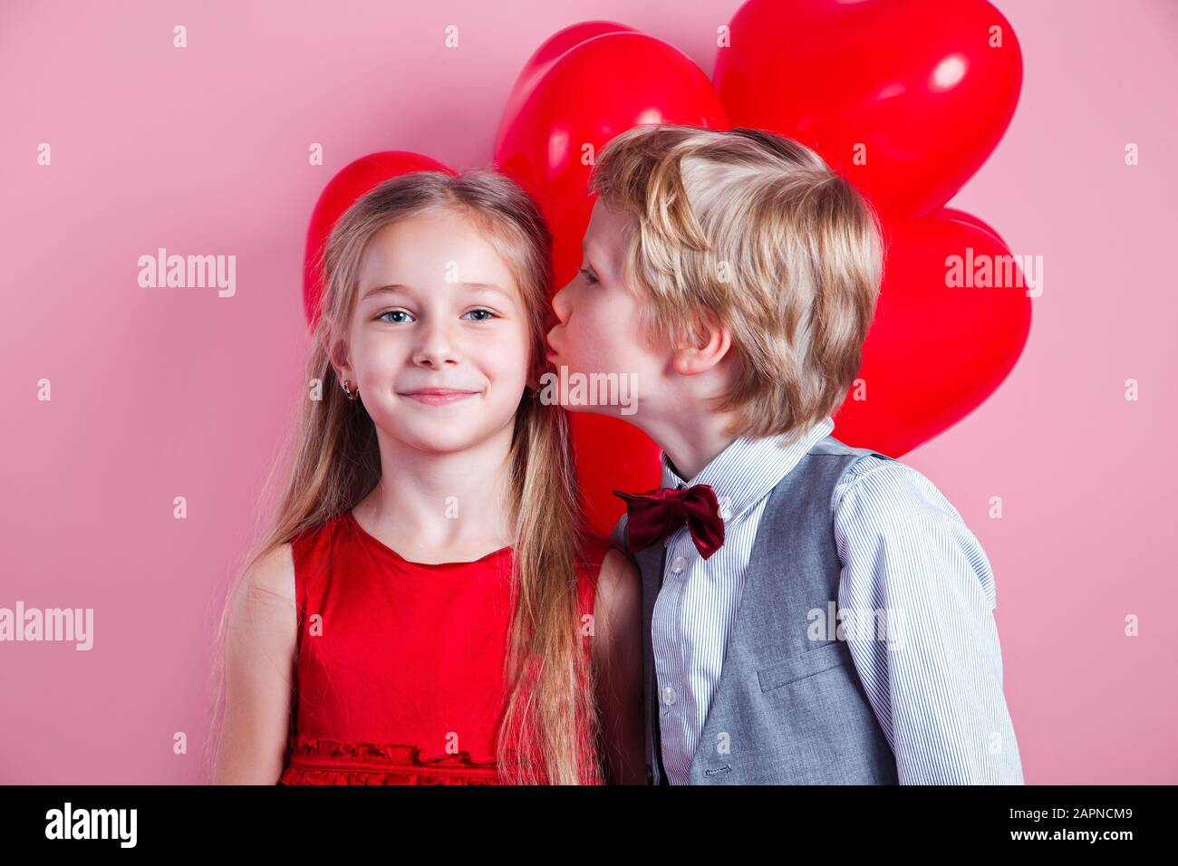 Little boy kissing beautiful little girl. Valentines day Stock Photo